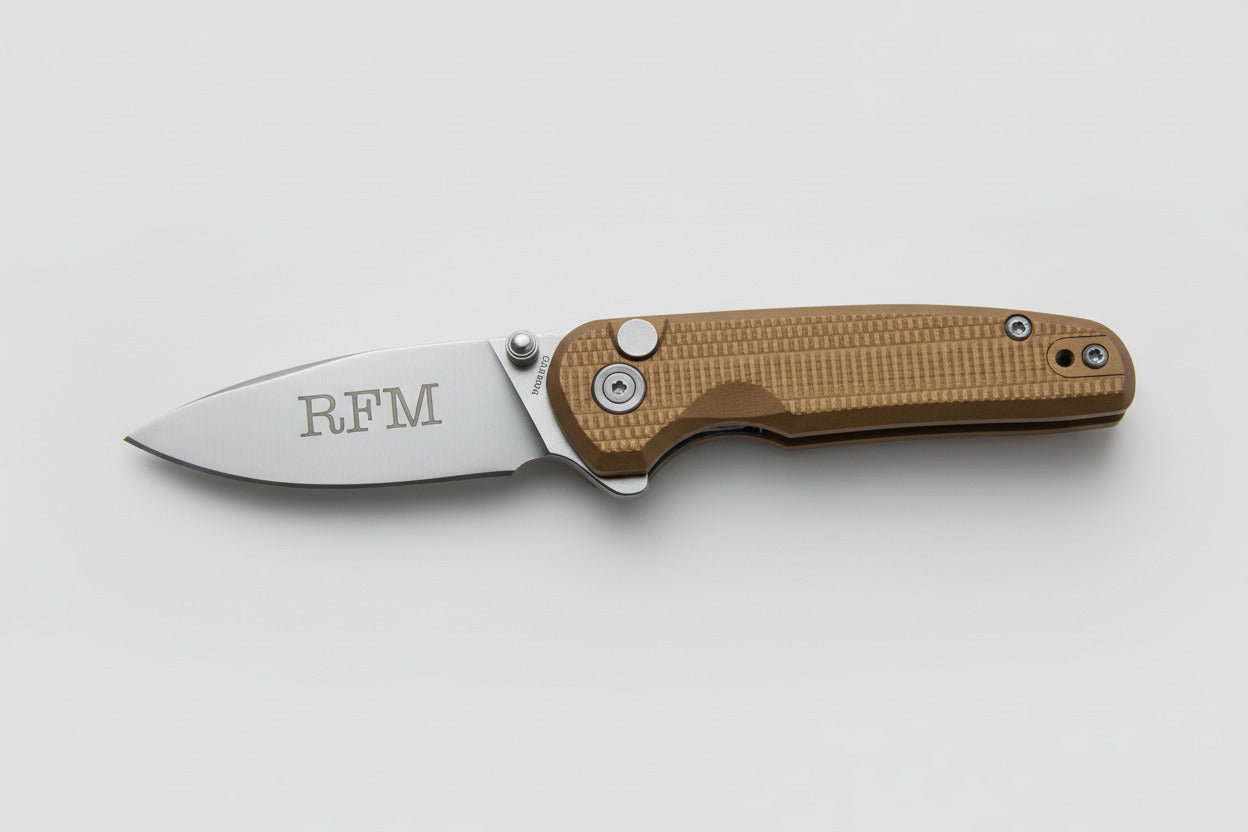 Folding knife with 'RFM' engraving on a beige background