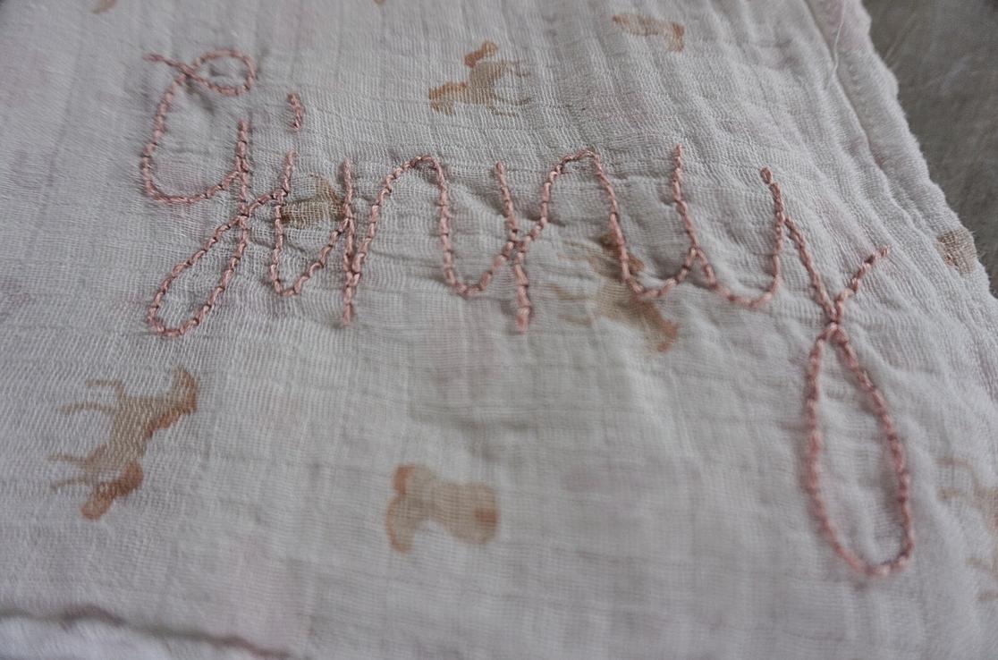 Embroidered name on a textured fabric background